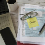tax-form-with-laptop-and-phone-on-desk-2026-03-17-00-44-12-utc