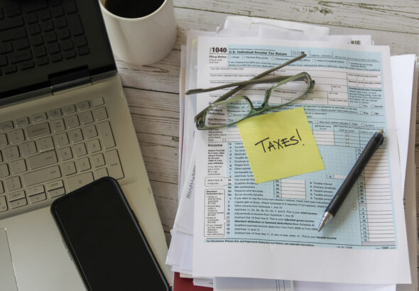 tax-form-with-laptop-and-phone-on-desk-2026-03-17-00-44-12-utc