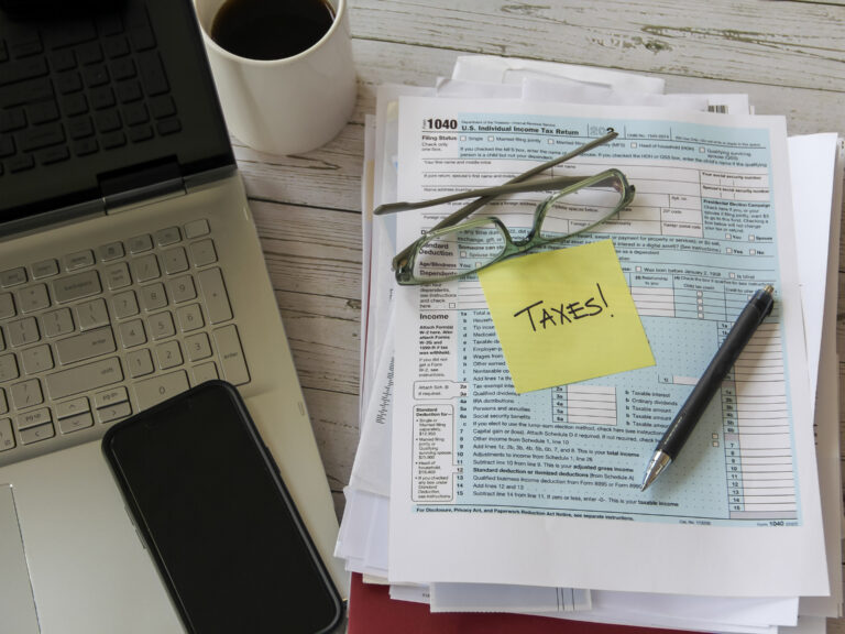 tax-form-with-laptop-and-phone-on-desk-2026-03-17-00-44-12-utc